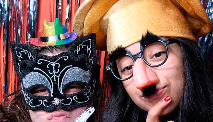 Two people wearing masks and glasses posing for a picture.
