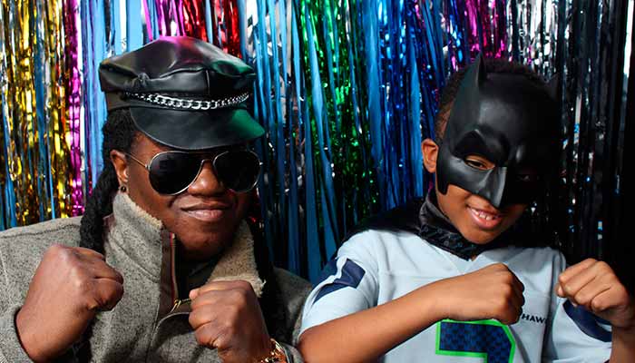 A man and boy in leather masks posing for the camera.