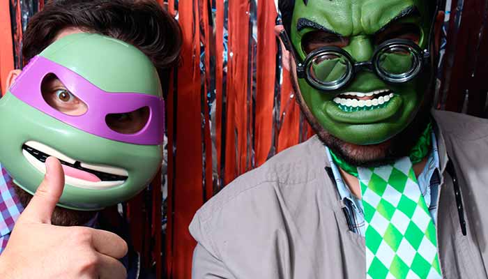 A man and woman wearing masks posing for the camera.