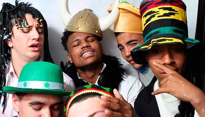 A group of people wearing hats and smiling.