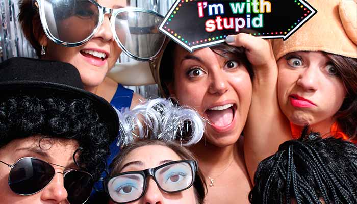 A group of people wearing silly glasses and hats.