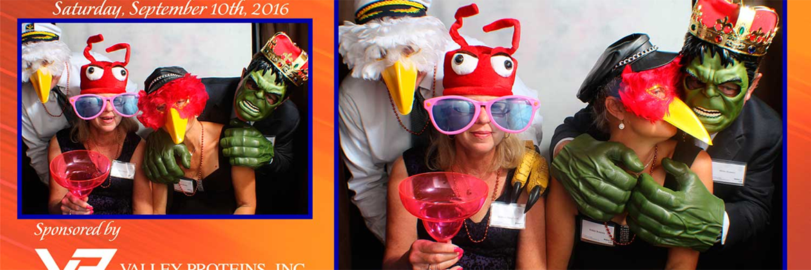 A woman wearing a lobster hat and holding a pink drink.