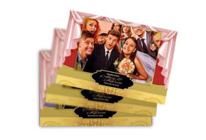 A stack of three wedding photo books with the bride and groom 's picture.