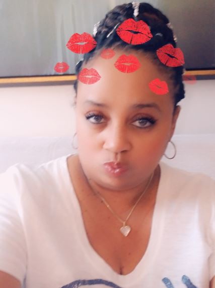 A woman with red lipstick on her head.