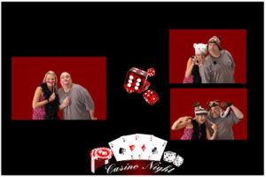 A couple posing for pictures in front of casino night props.