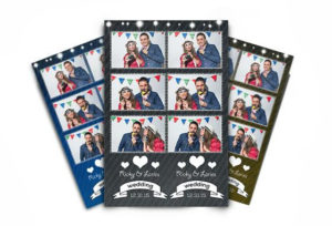 A couple is taking pictures in the photo booth.