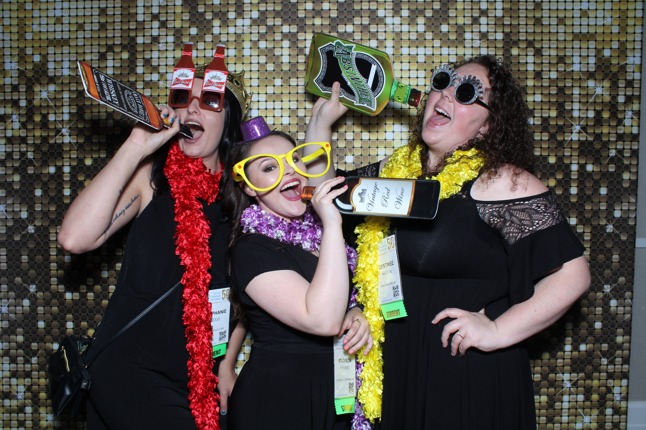 Three women are posing for a photo booth.