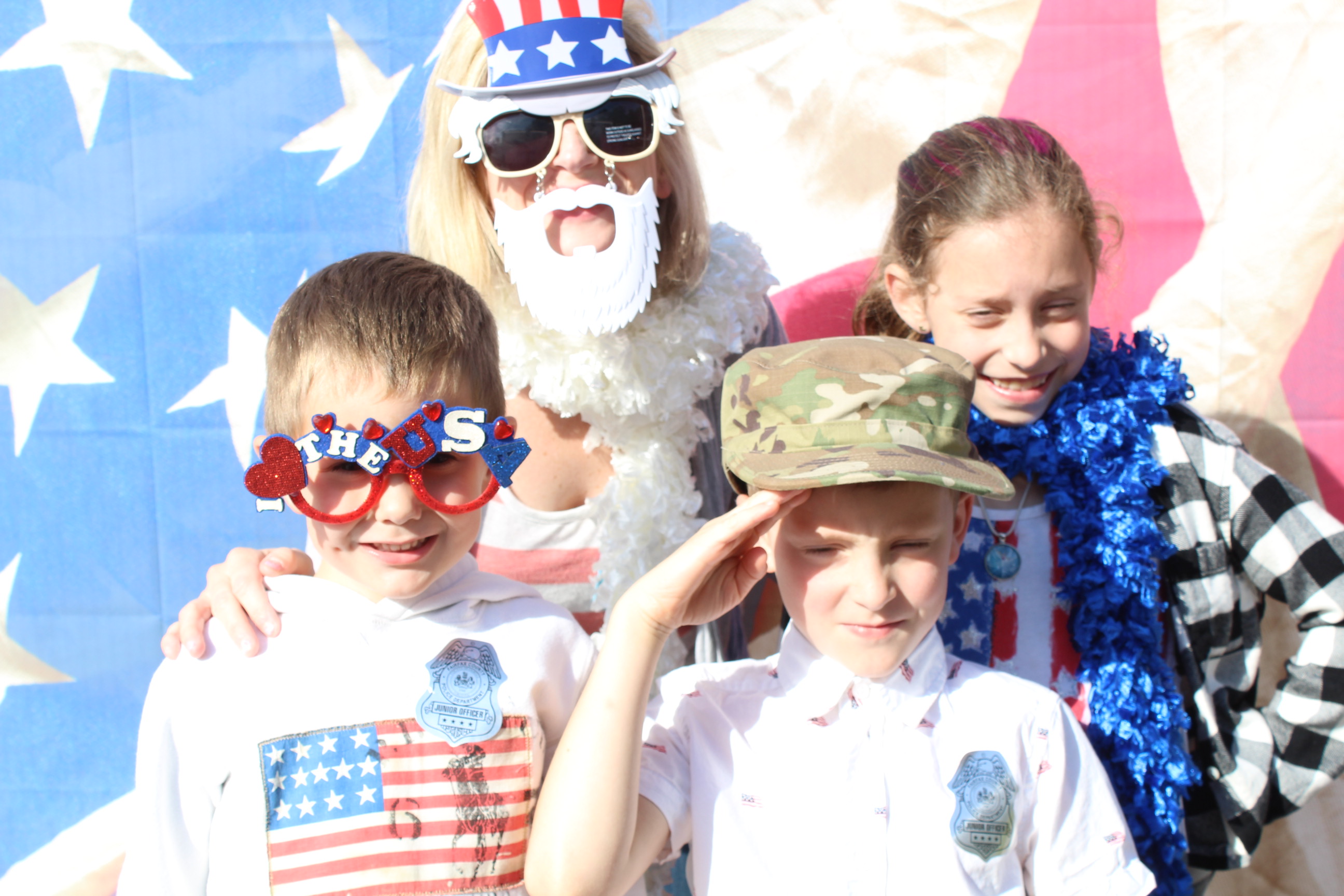 A group of kids wearing patriotic clothing and hats.