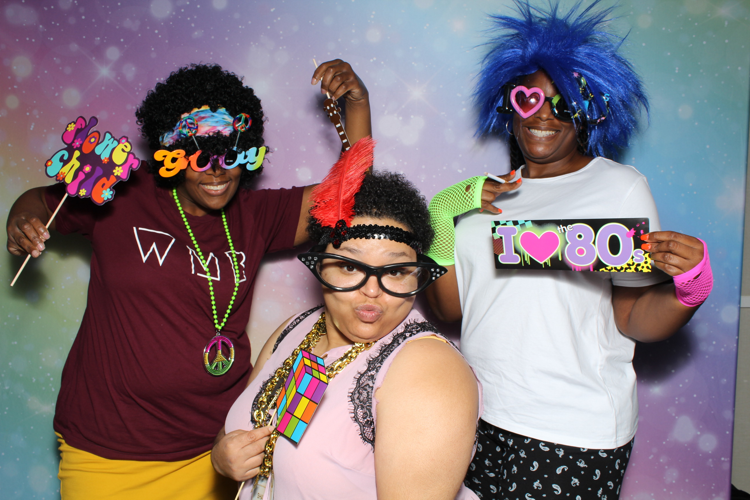 A group of people wearing colorful wigs and glasses.