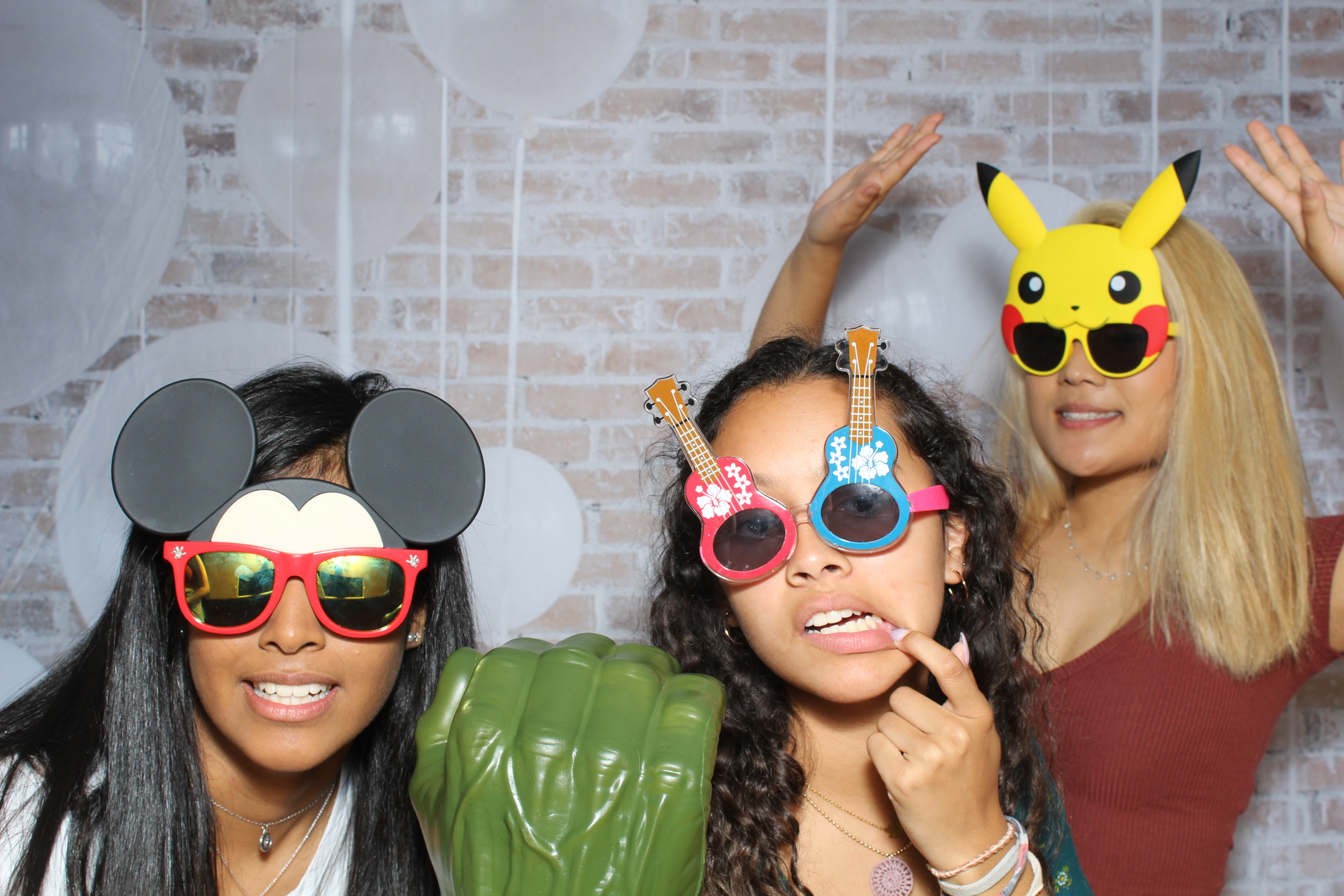 Three women posing for a picture with glasses on.