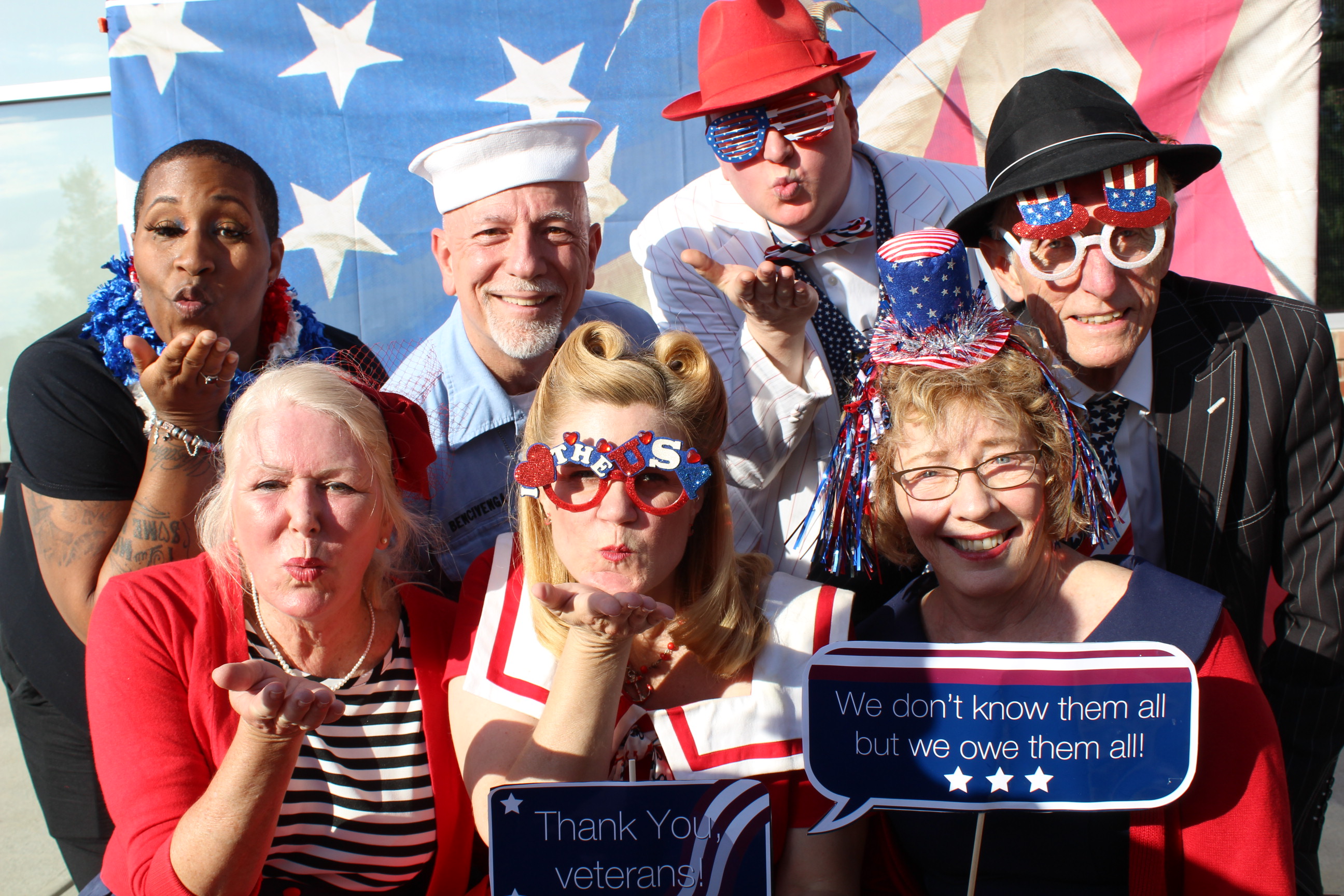 A group of people wearing patriotic hats and glasses.