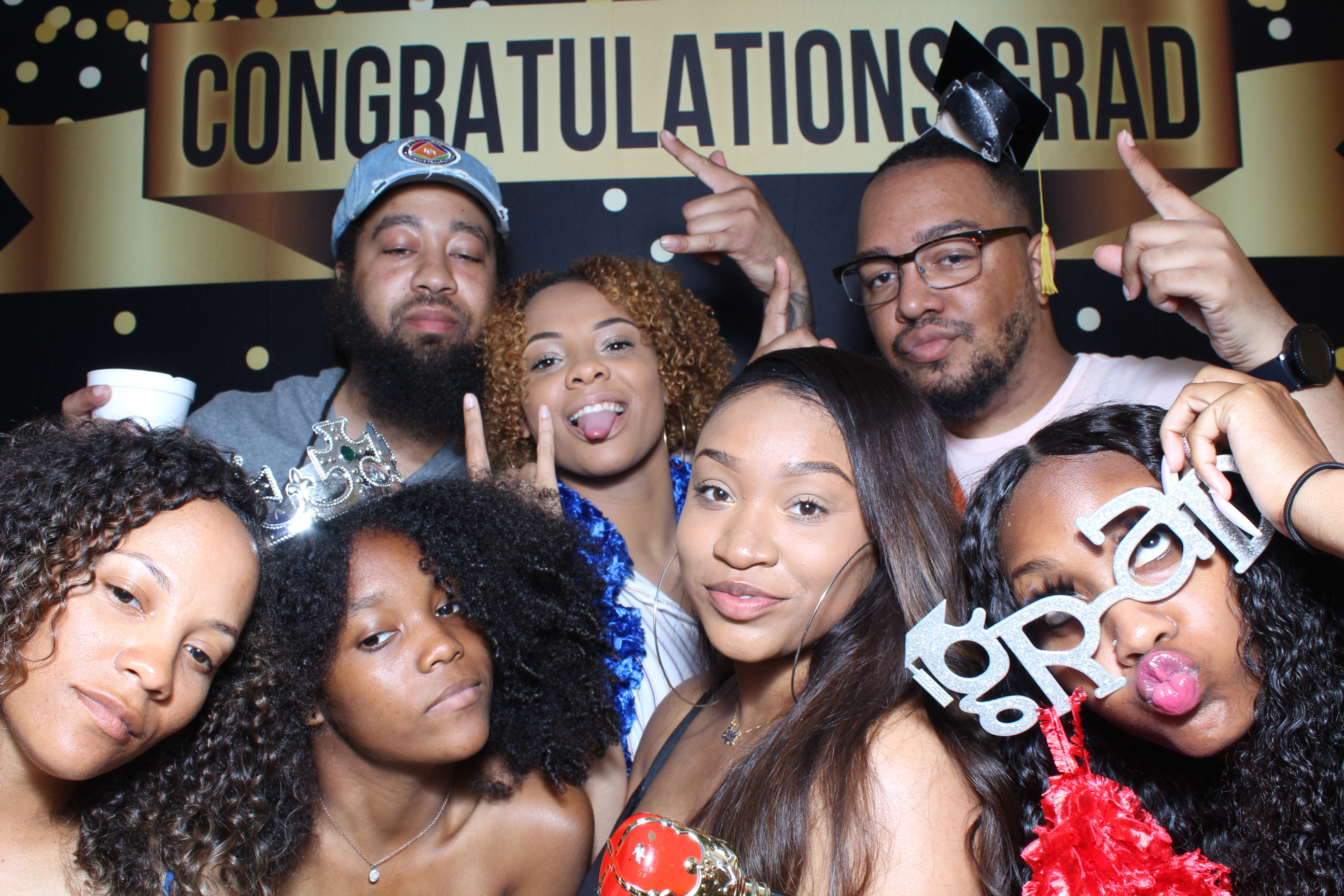 A group of people posing for the camera in front of a congratulations sign.