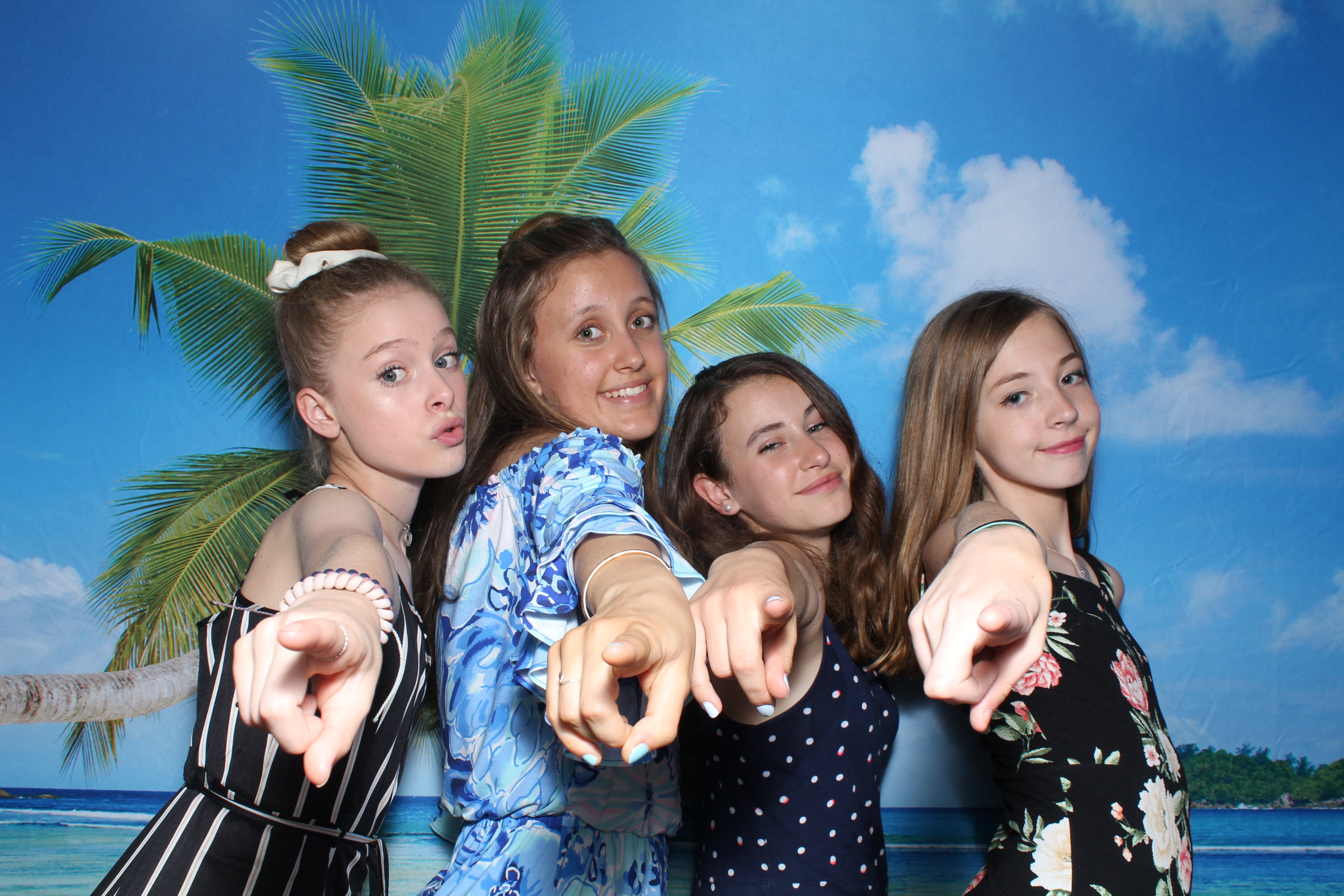 A group of girls pointing at the camera.