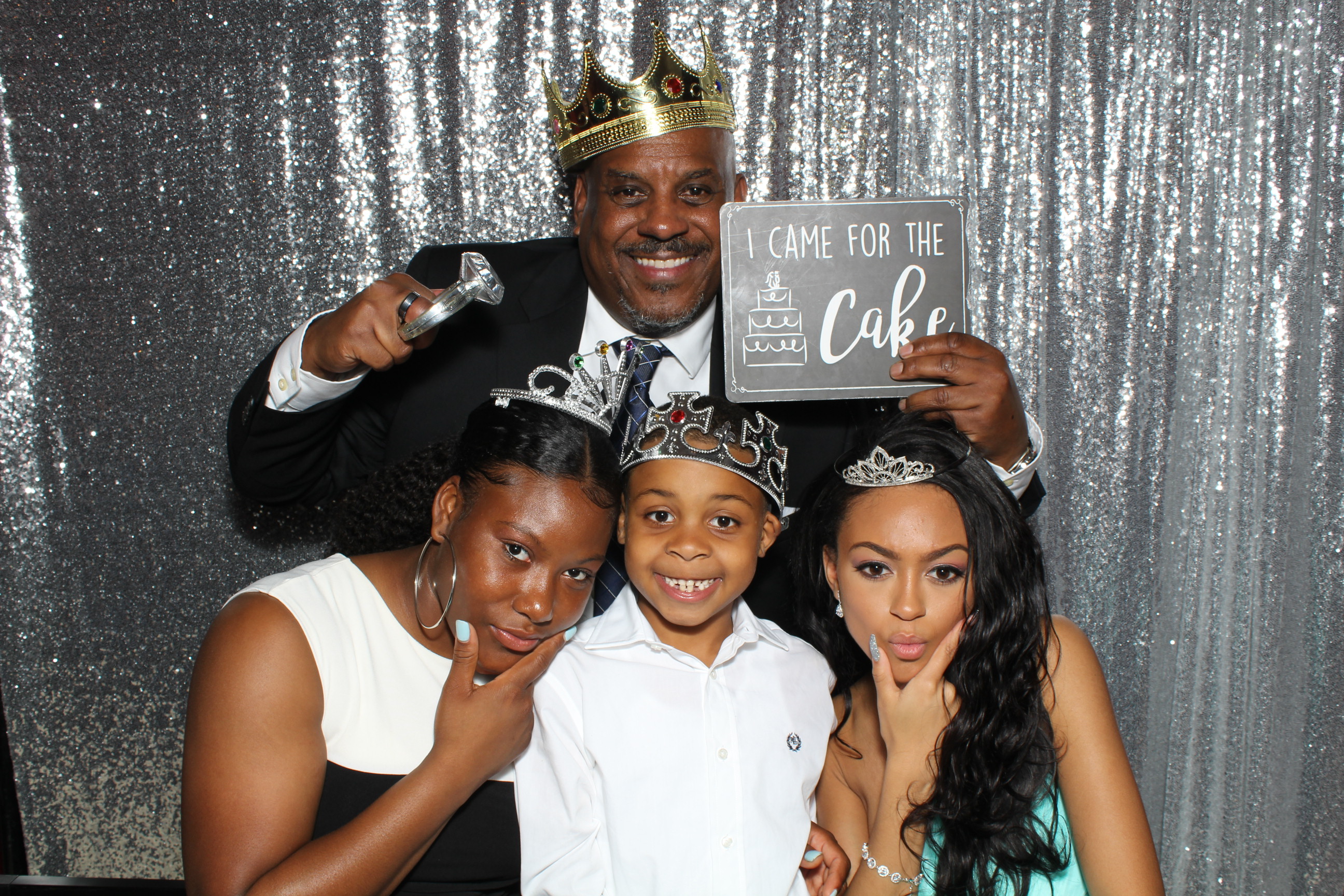 A man and two women posing with a young boy.