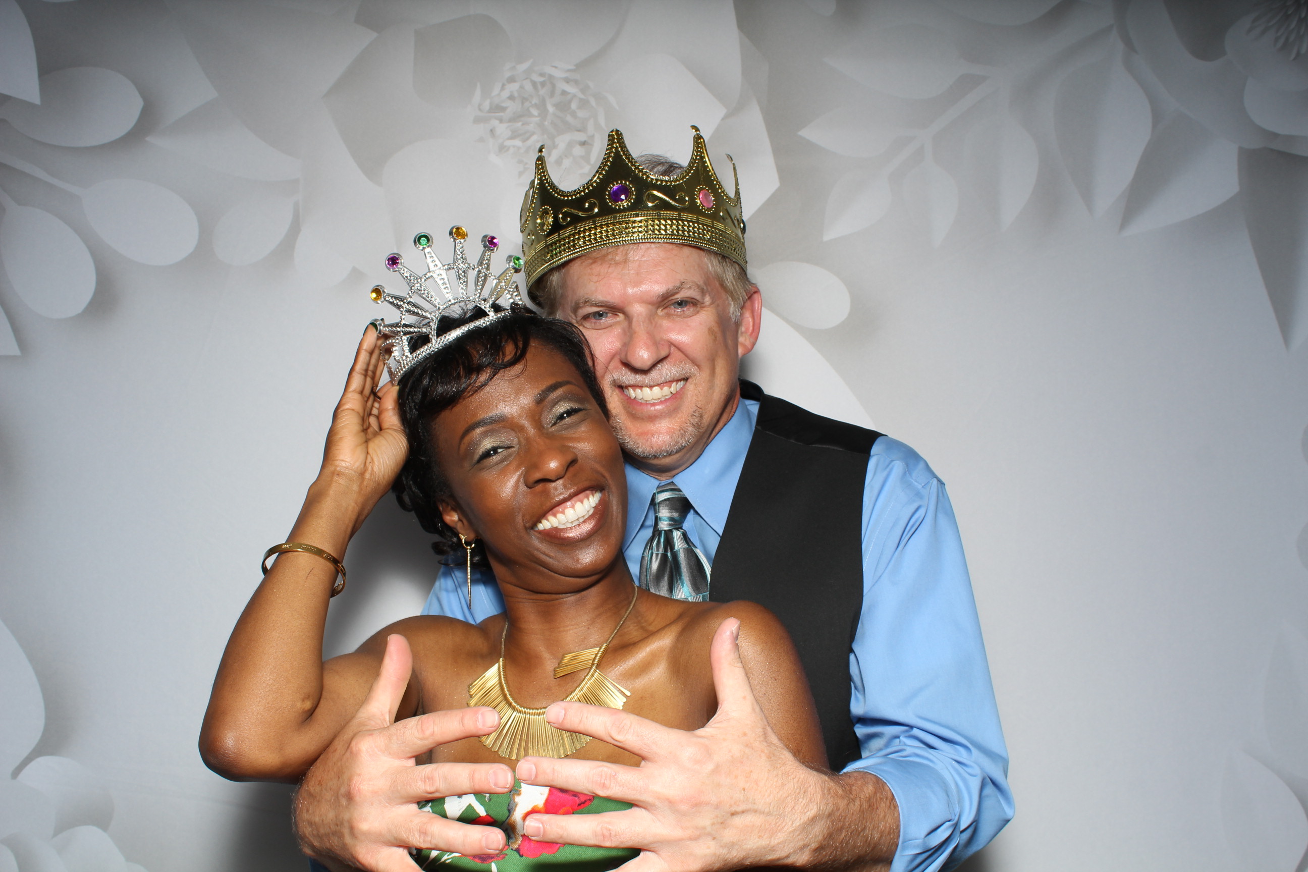 A man and woman posing for a photo booth picture.