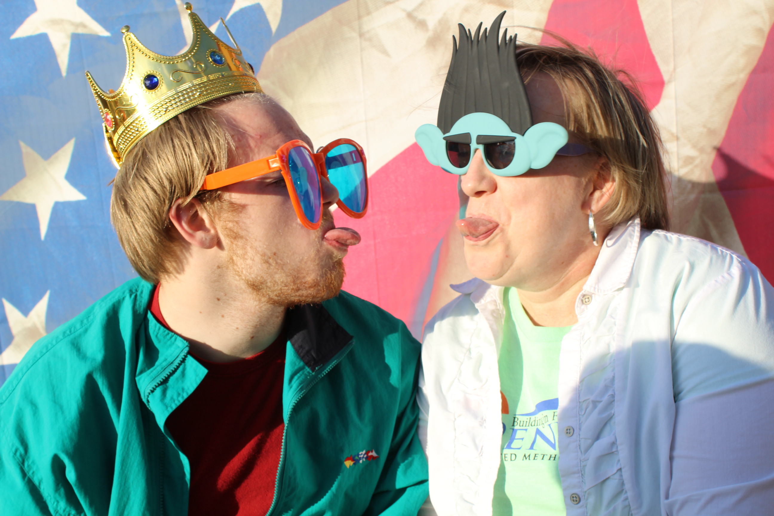 A man and woman wearing glasses, hats and crowns.