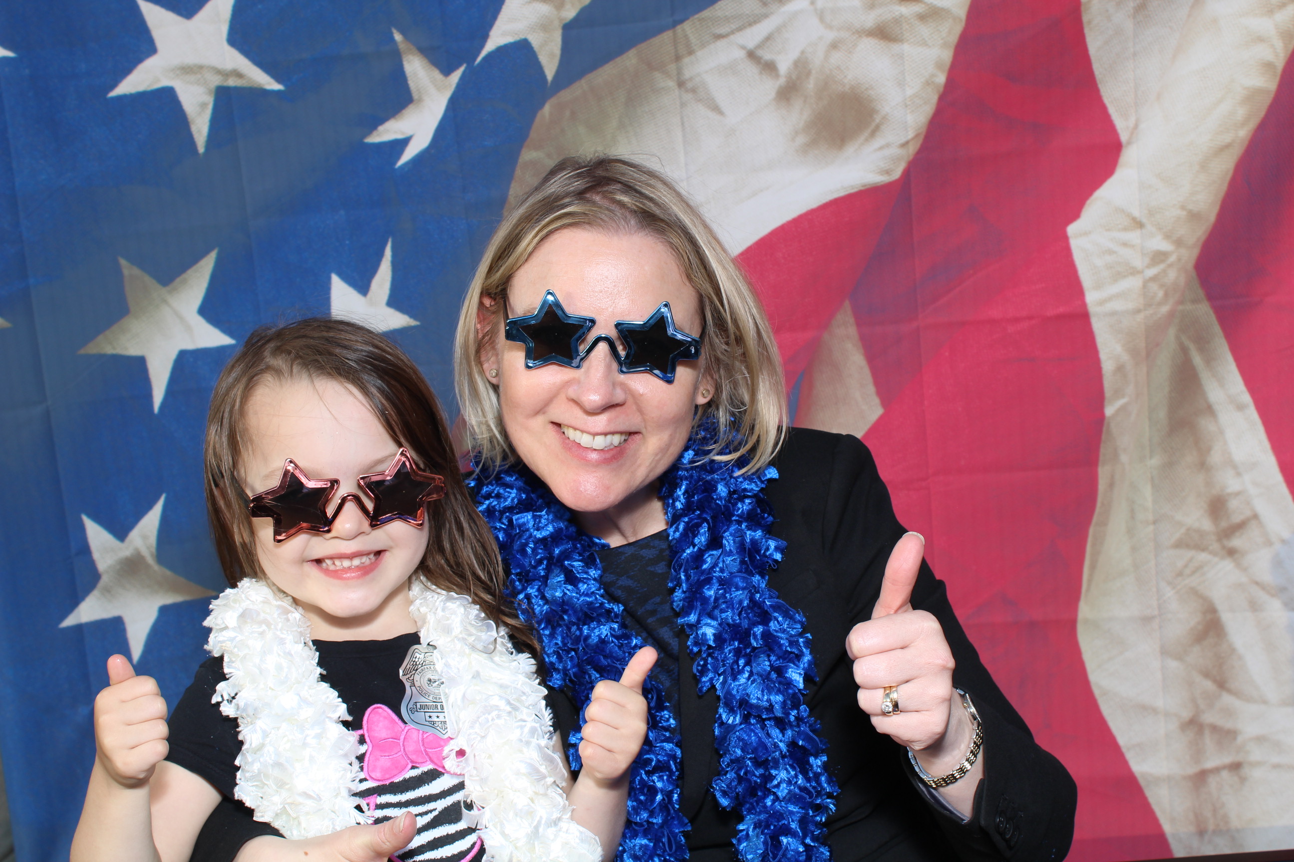 A woman and girl in sunglasses posing for the camera.
