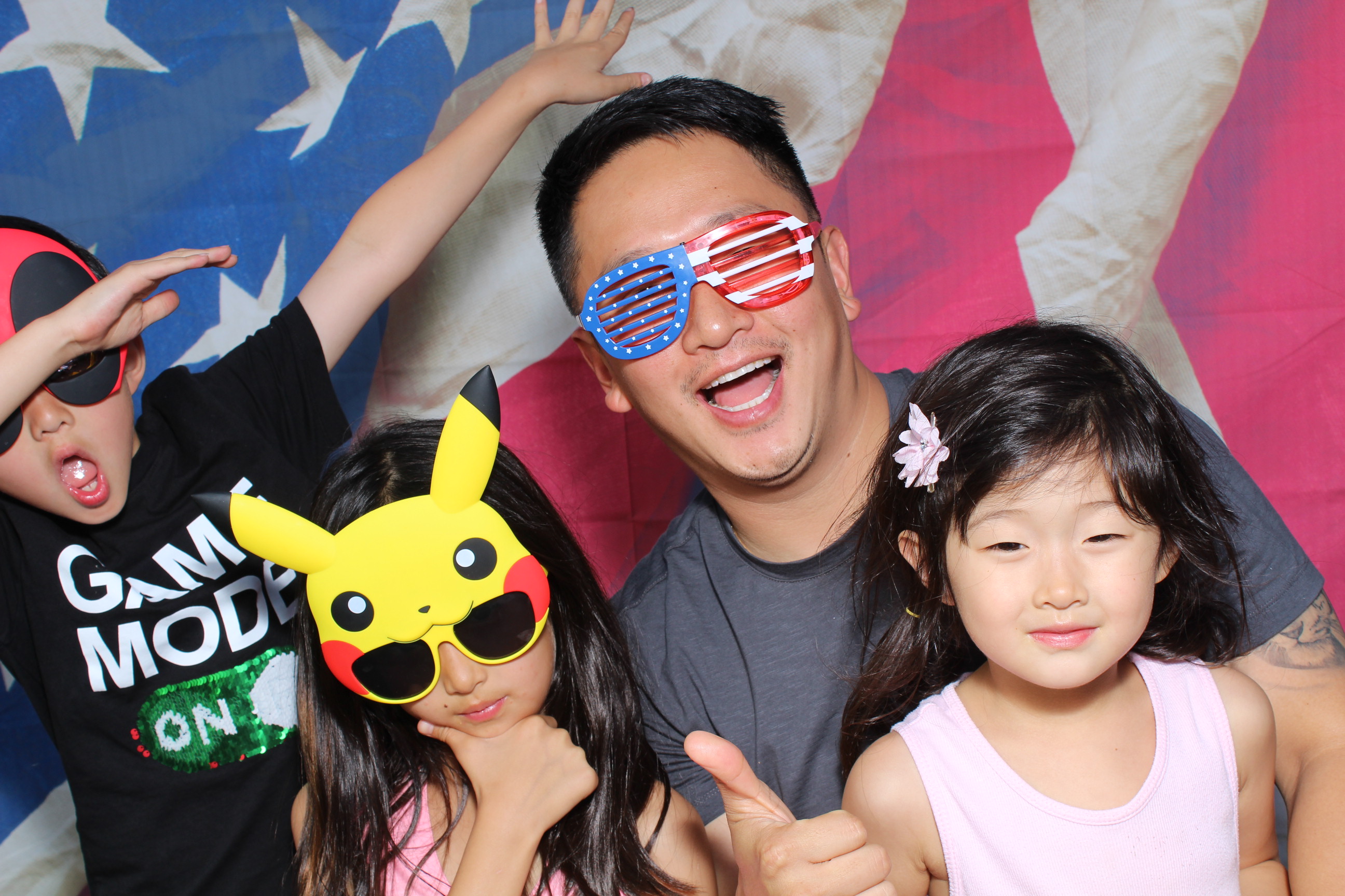 A man and two girls wearing masks posing for the camera.