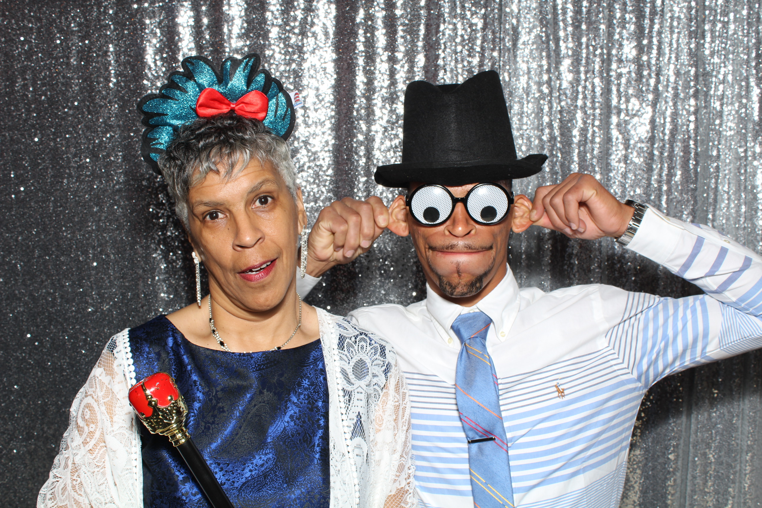 A man and woman posing for a photo booth picture.