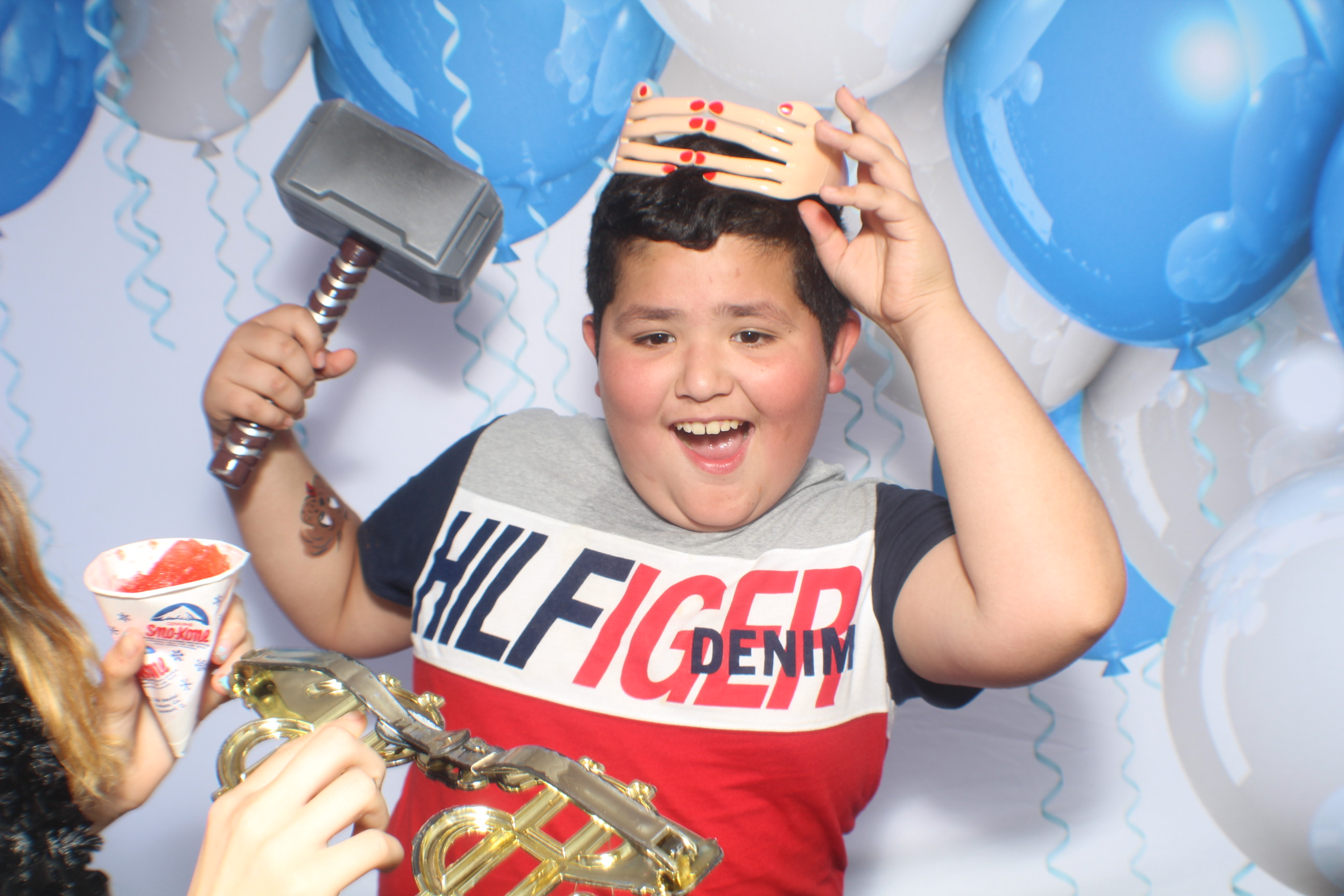 A boy holding a hammer and a snake