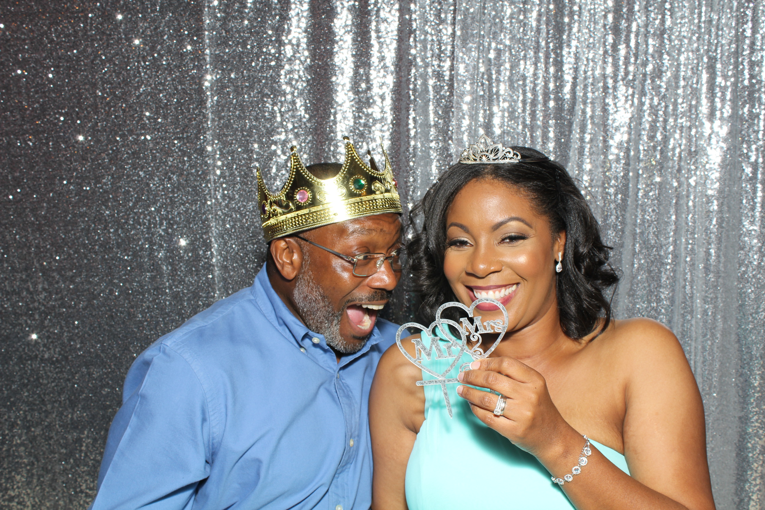 A man and woman posing for a photo booth picture.
