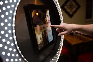 A person touching the screen of a mirror