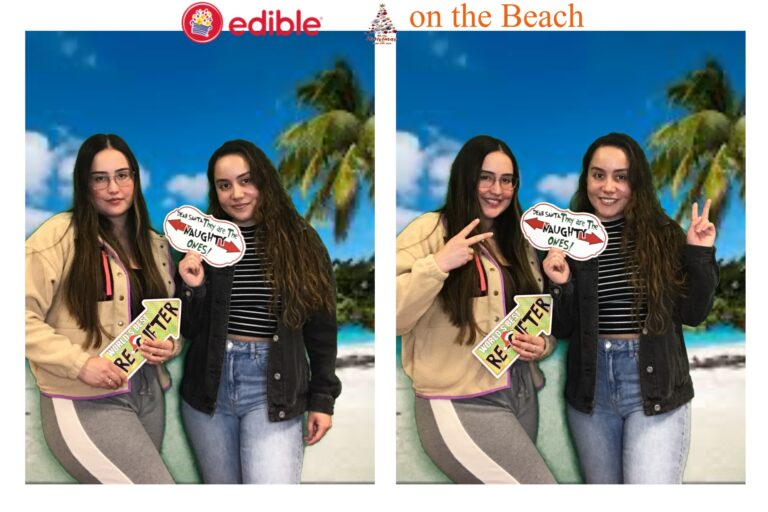 Two women holding up signs in front of a beach.