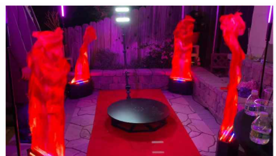 A room with red lighting and statues on the ground.